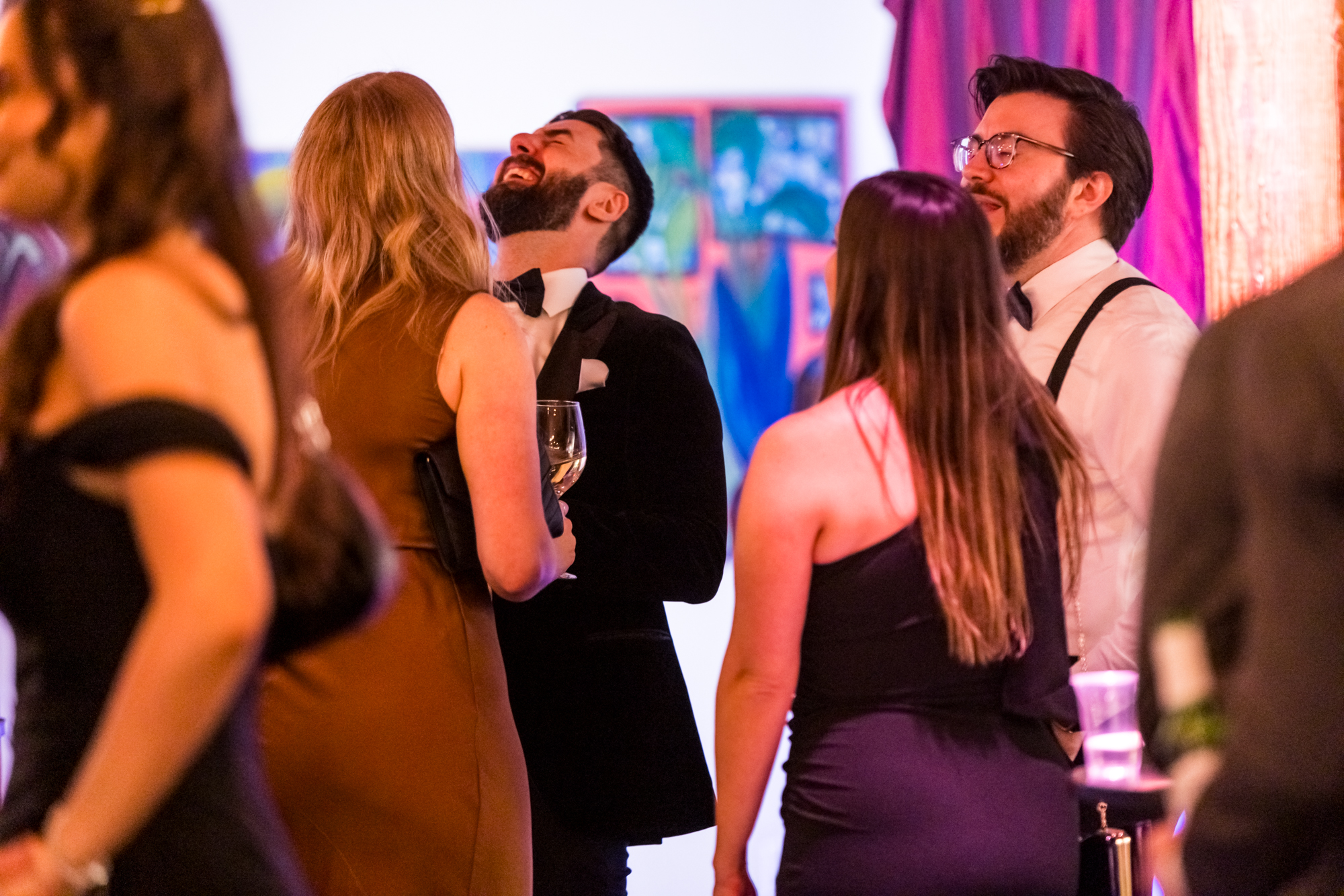 Guests laughing together at an evening celebration