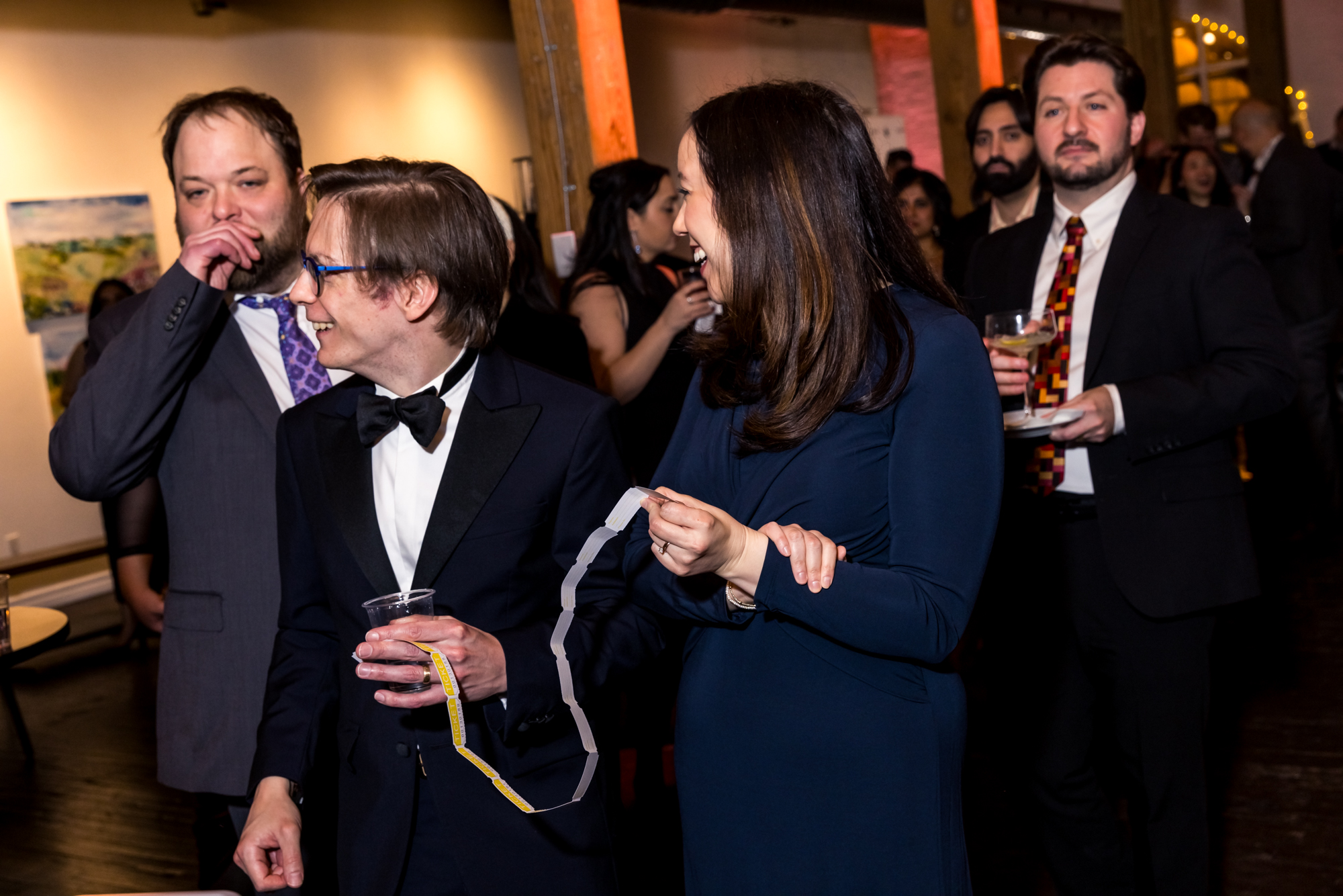 Guests sharing a lively moment at an evening gathering