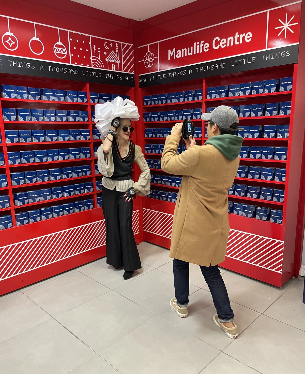 A guest enjoying an interactive seasonal brand experience while another guest takes a photo